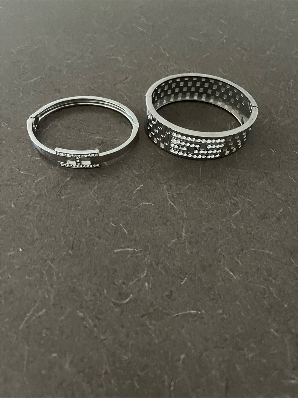 2 Ladies Silver-Tone Bracelets - one missing couple stones
